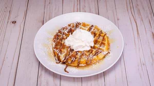 Drizzled with dulce de leche, lechera then sprinkled with powdered sugar and topped with whipped cream