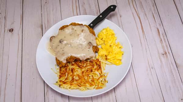 Two eggs* Any Way You Like 'Em served with a breaded and fried ground beef steak smothered with country gravy, hashbrowns, and two buttermilk pancakes