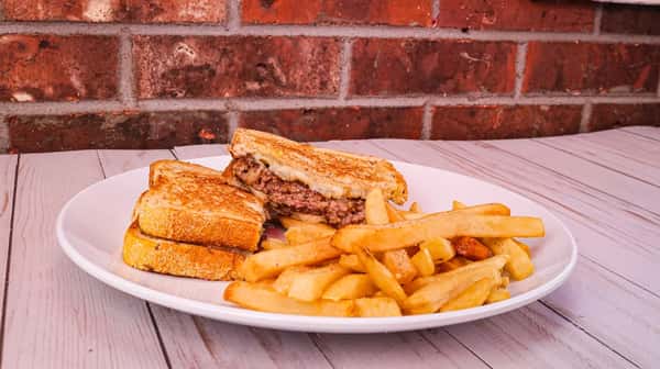 Grilled rye, ground beef patty, sautéed onions, and Swiss cheese