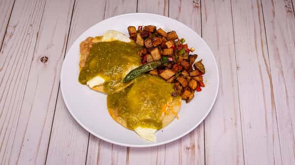 2 fried tortillas topped with refried beans, two eggs*, cheddar and Monterrey jack cheese, and your choice of red or green sauce. Served with house potatoes