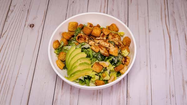 Romaine lettuce tossed in Caesar dressing, grilled chicken, Parmesan cheese, topped with avocado and croutons