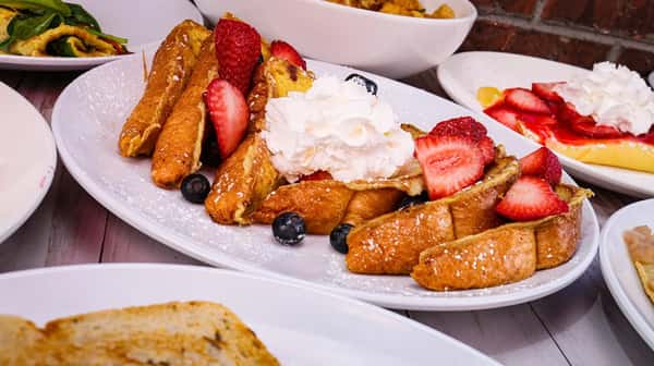Fluffy thick style French toast topped with fresh seasonal berries