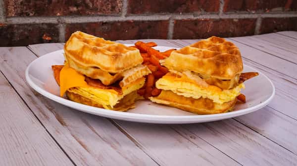 How about some eggs*, American cheese and bacon sandwiched between our delicious Belgian waffles!! Served with hashbrowns