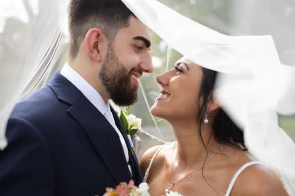couple under wedding veil