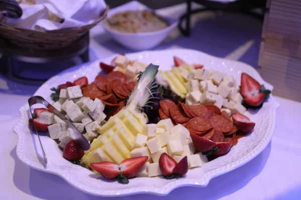 different cheese and cured meats on white plate