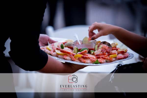 server passing shrimp cocktail