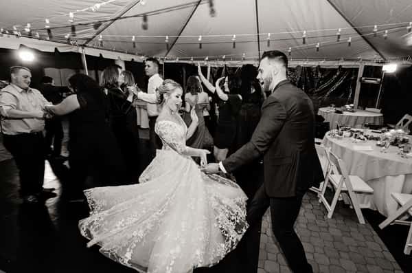 couple dancing under tent