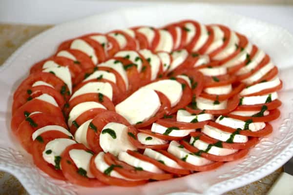platter of swirled tomato and mozzarella cheese
