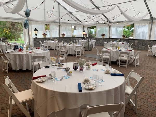 tables set up under tent for party
