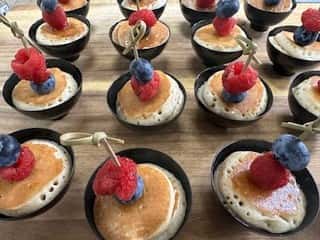 mini pancakes in black cups