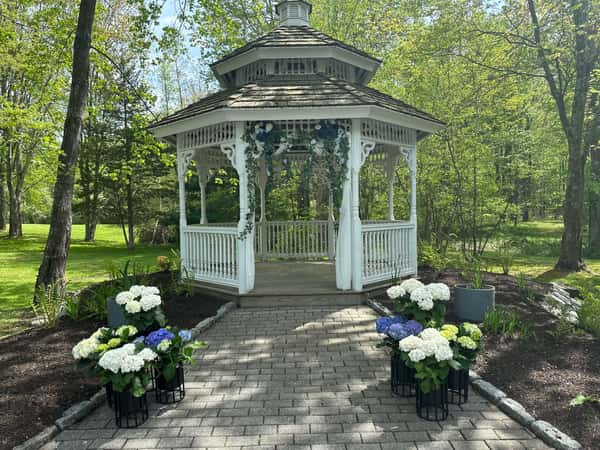 white gazebo with white and blue flowers