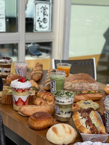 table of food, including breads, sandwiches, anddesserts