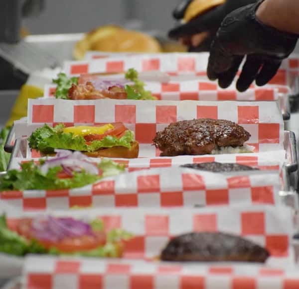 person prepping burgers