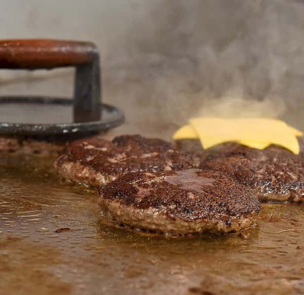 burgers cooking on grill