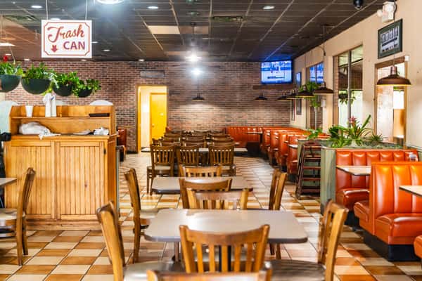 The interior dining area of The Butcher Shop restaurant featuring wooden tables and chairs