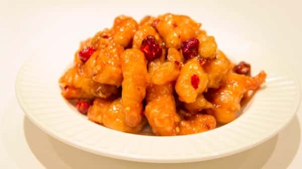 bowl of sweet and spicy chicken with roasted chili peppers