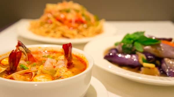 three bowls of assorted soups and rice, with shrimp and vegetables
