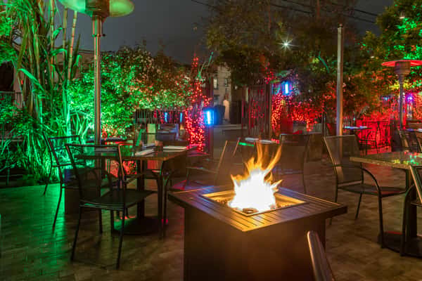 outdoor seating area at night with fire feature