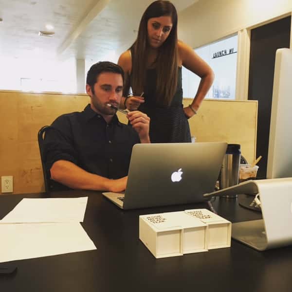 guests working on a laptop with cups of coffee at the grind location