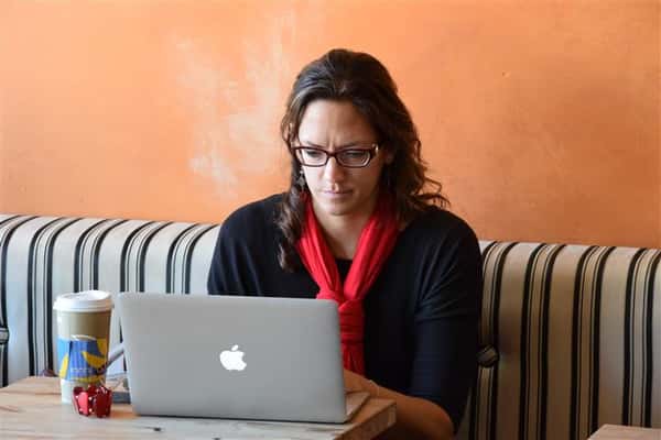 guest working on laptop computer at table at city center location