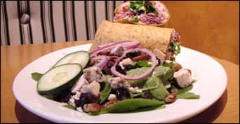 wrap plated with a side spinach salad