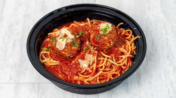 Spaghetti and meatballs in red sauce, topped with Parmesan and parsley, in a black bowl.