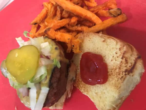 beyond burger with pickles and ketchup with a side of sweet potato fries & a snapple