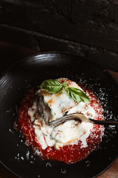 Italian dish with rich marinara sauce, mozzarella and fresh basil