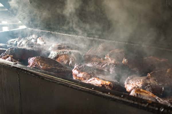 Briskets being cooked in pit