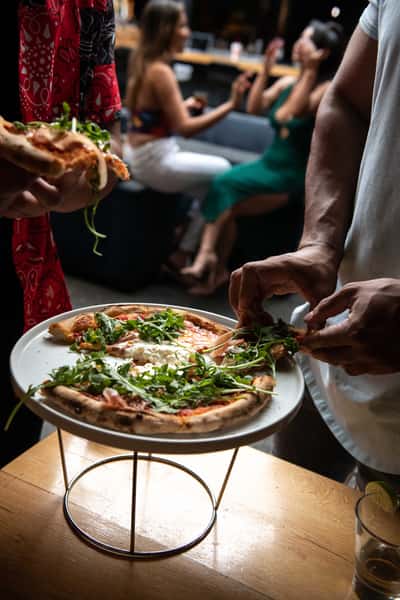 friends sharing artisan pizza