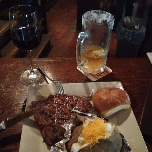 steak, baked potato and a roll