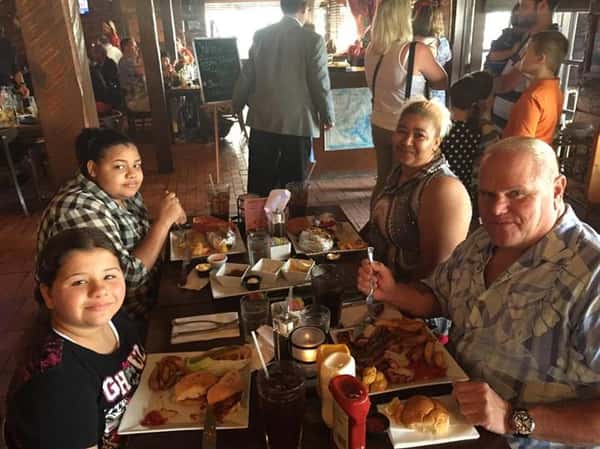 people sitting at table enjoying a meal