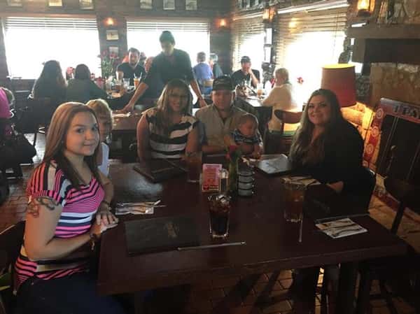 people sitting at table enjoying a meal