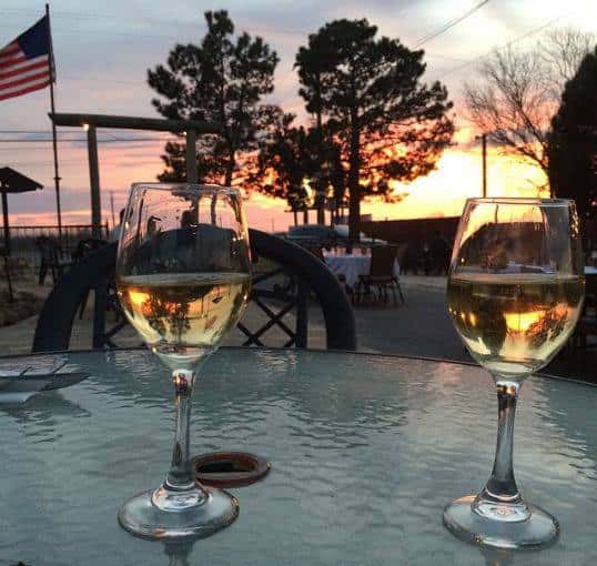 two glasses of wine on a table outside