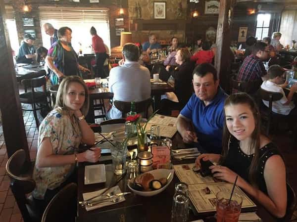 people sitting at table enjoying a meal