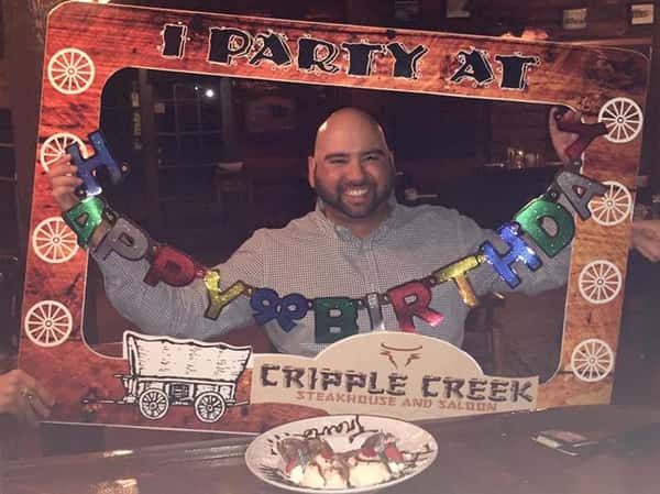 male holding happy birthday sign
