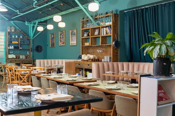 Interior of restaurant with tables laid and large windows