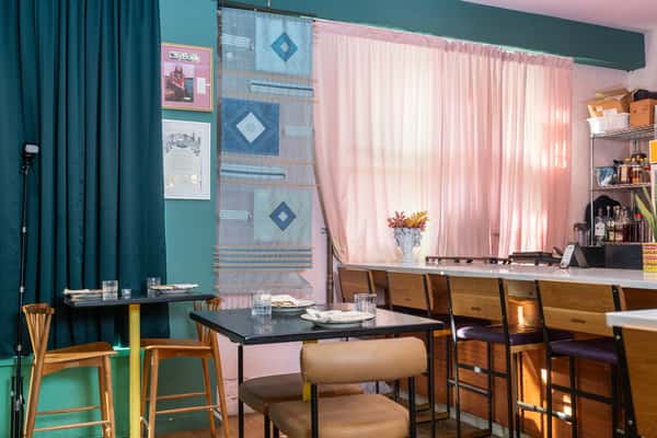 Interior of restaurant with tables laid and large windows