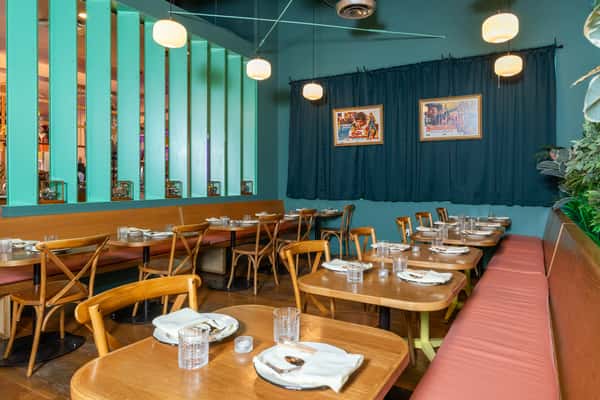 Interior of restaurant with tables laid and large windows