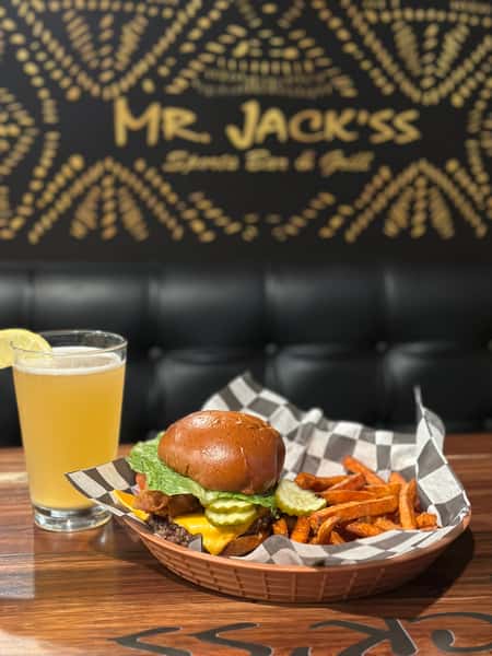 A tasty breakfast from Mr. Jack'ss Sports Bar & Grill. A stack of burger, sweet potato fries and beer with a lemon wedge.