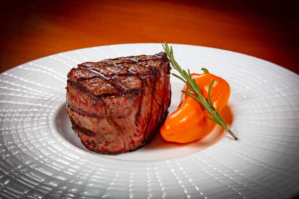 A petite steak served with a pepper