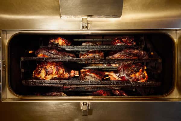 A spread of Billy Bob's BBQ family packs including smoked meats and home-cooked sides.