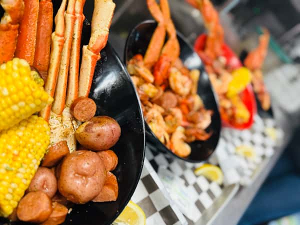 1lb Snow Crab, 1/2lb Sausage, Corn and Potatoes with a Drawn Butter and Old Bay Seasoning.