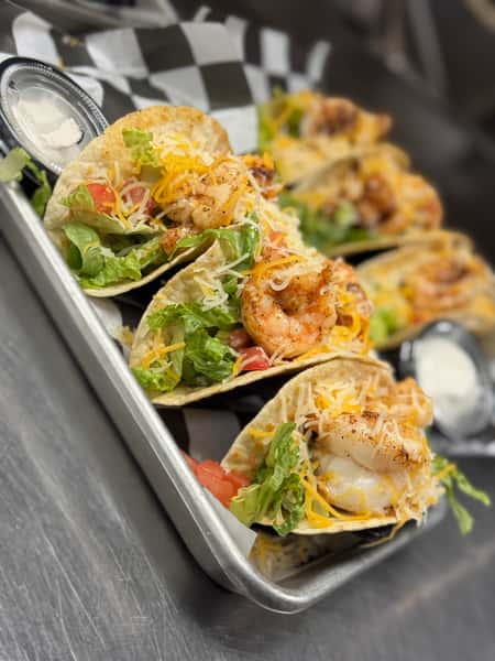 Shrimp Tacos come with one side.