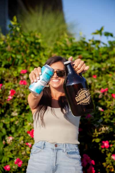 girl with growler and beer can