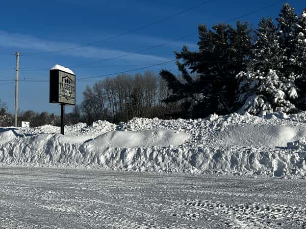 snow covered parking lot and sign