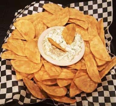 Spinach and artichoke dip with tortilla chips.