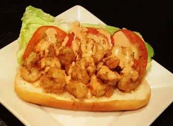 Po Boy sandwich. Fried shrimp, lettuce, tomato and County Seat sauce.