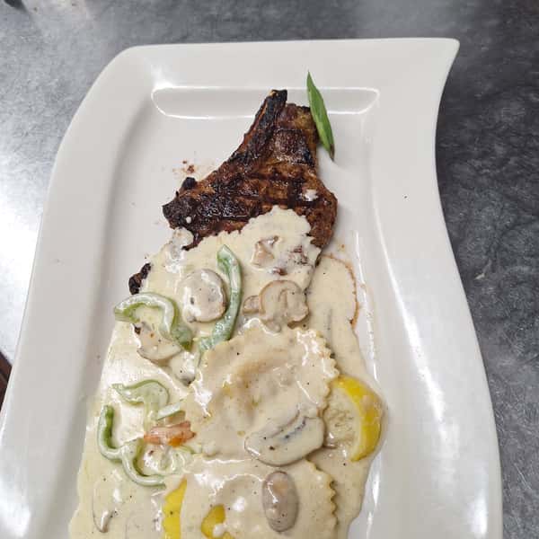 TODAY SPECIAL 10 oz Pork Chop with side of shrimp scampi ravioli in lemon creamy sauce with broccoli and carrotsww