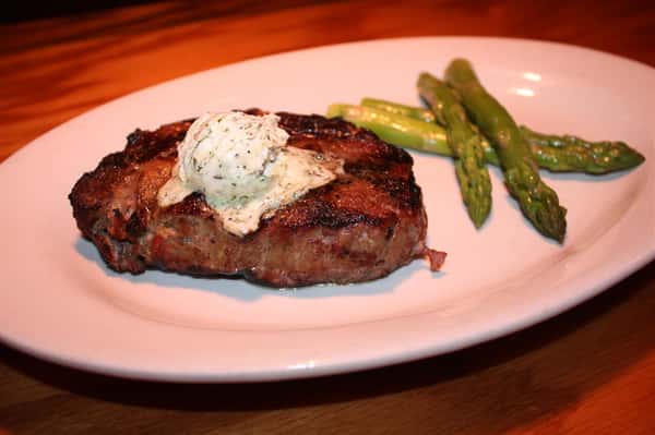 steak with a lob of butter and asparagus